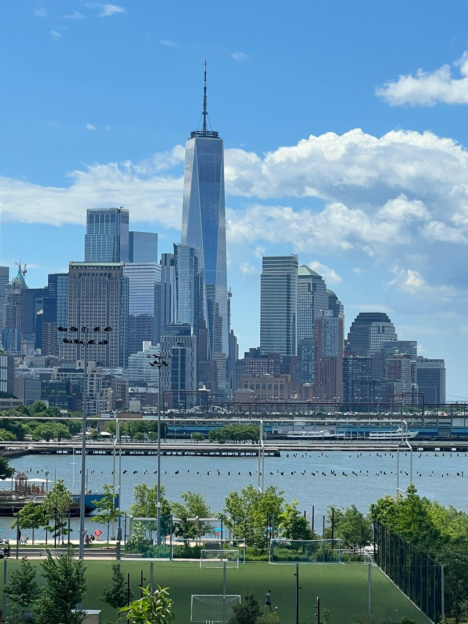 May be an image of the Brooklyn Bridge and skyscraper